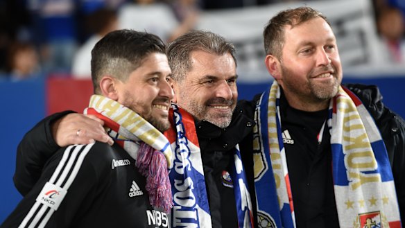 Papas, left, celebrates Yokohama F. Marinos' title win last season with Ange Postecoglou and Peter Cklamovski.