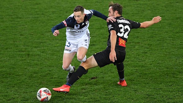 Victory's Anthony Lesiotis rides a tackle from the Jets' Angus Thurgate.