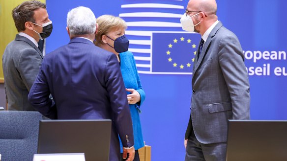 French President Emmanuel Macron, German Chancellor Angela Merkel and European Council President Charles Michel at the Europa Building, Brussels, last week. French and German are two of the council’s three working languages.