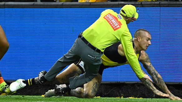 Dustin Martin collides with the goal umpire. 