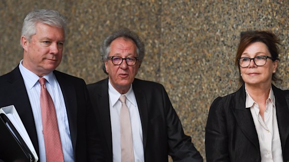 Geoffrey Rush, arriving at court with wife Jane Menelaus on Monday, has hired a third barrister to stop the Daily Telegraph introducing new evidence.