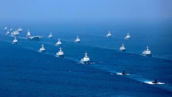 China's Liaoning aircraft carrier is accompanied by navy frigates and submarines conducting exercises in the South China Sea in 2018.