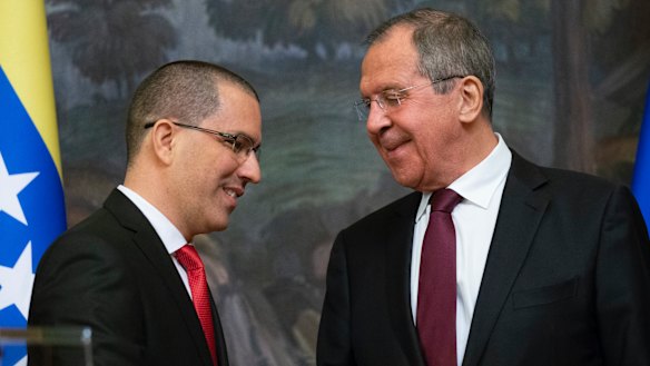 Russian Foreign Minister Sergey Lavrov, right, and Venezuelan Foreign Minister Jorge Arreaza shake hands after their joint news conference following the talks in Moscow.