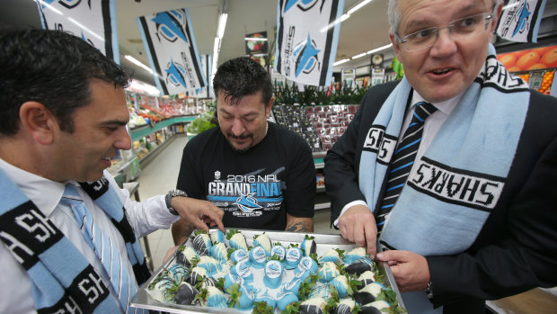 Then-treasurer Scott Morrison and Mayor Carmelo Pesce eating coloured Shark strawberries at a Cronulla Fruit fair. 