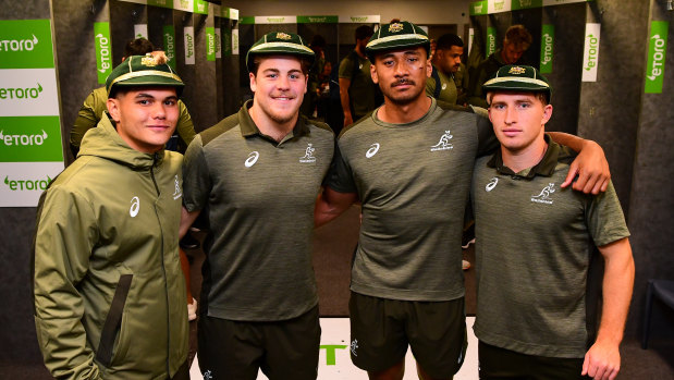 (From left) Noah Lolesio, Fraser McReight, Irae Simone and Tate McDermott crack half-smiles after receiving their first Test caps post-game.