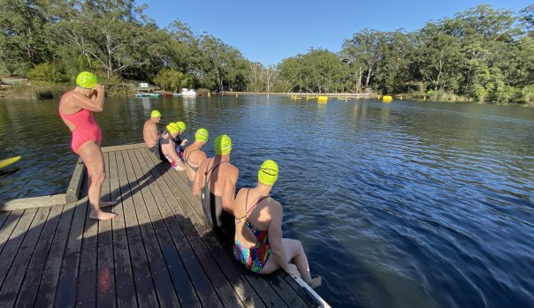 Swimmers prepare to enter the water for the two-kilometre open swim at Lake Parramatta, in the upper reaches of Parramatta River.