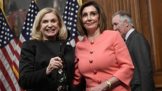 House Speaker Nancy Pelosi stands with House Oversight and Government Reform Committee Chair Representative Carolyn Maloney, left, after she signed the resolution to transmit the two articles of impeachment against President Donald Trump to the Senate for trial on Capitol Hill in Washington. 