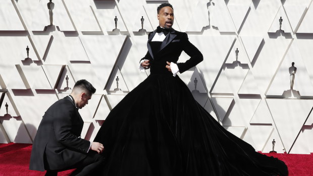 Billy Porter has his gown tweaked on the Oscars red carpet.