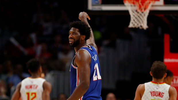 Joel Embiid reacts after hitting a three against the Hawks.