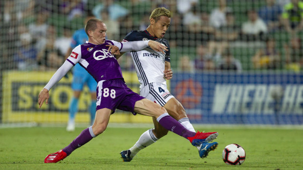 Firing on all cylinders: Melbourne's Keisuke Honda battles for possession with Neil Kilkenny of Perth.