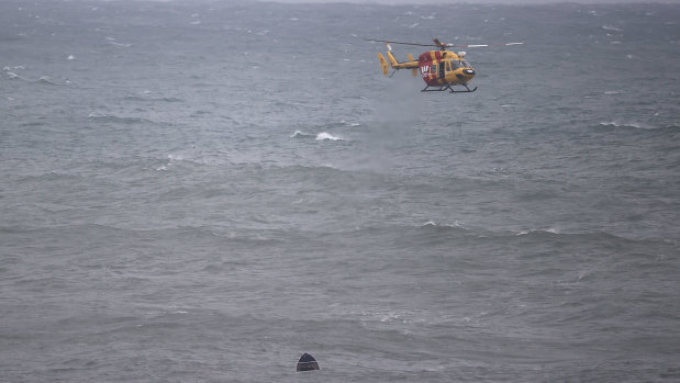 Search crews look for survivors after an upturned dinghy was spotted in the water.  