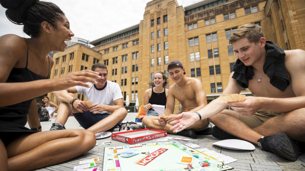 German backpackers get involved in a game of Monopoly in front of the MCA as they wait for the fireworks to start.