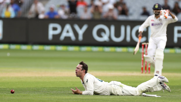 Australia's Travis Head reacts after dropping a catch off India's Ajinkya Rahane, right, on Sunday.
