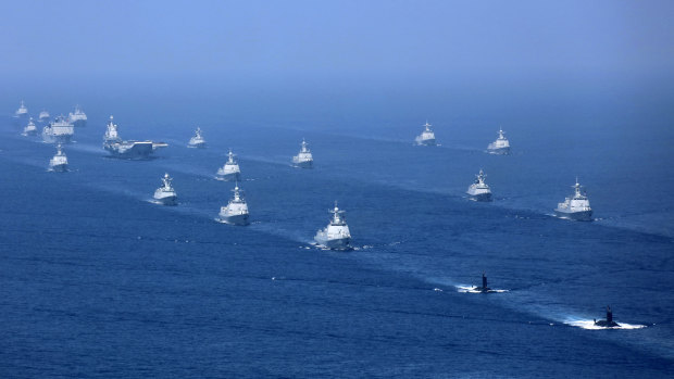 China's Liaoning aircraft carrier is accompanied by navy frigates and submarines conducting exercises in the South China Sea in 2018.