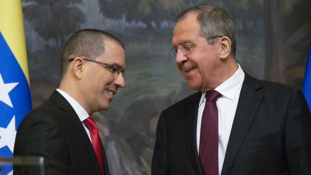 Russian Foreign Minister Sergey Lavrov, right, and Venezuelan Foreign Minister Jorge Arreaza shake hands after their joint news conference following the talks in Moscow.