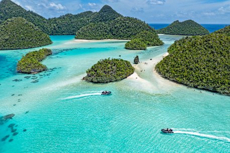 Zodiacs exploring Wayag Island in Raja Ampat.