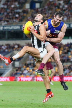 Crunch: Josh Daicos is cleaned up by Darcy Gardiner after taking a mark.