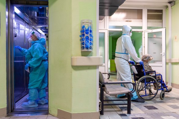 A medic wearing a special suit to protect against coronavirus transfers a patient with coronavirus at the City hospital No. 52 for coronavirus patients in Moscow, Russia.