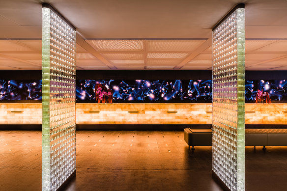 The art-gallery-like lobby with glass-brick screens and an LED video wall.