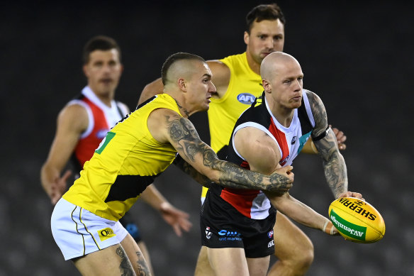 Dustin Martin, left, tackles Zak Jones, right, during the Tigers' round four loss to St Kilda. 