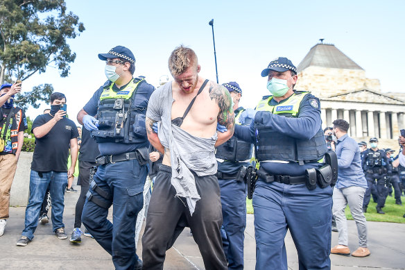A man is arrested at the anti-lockdown protest at the Shrine of Remembrance.
