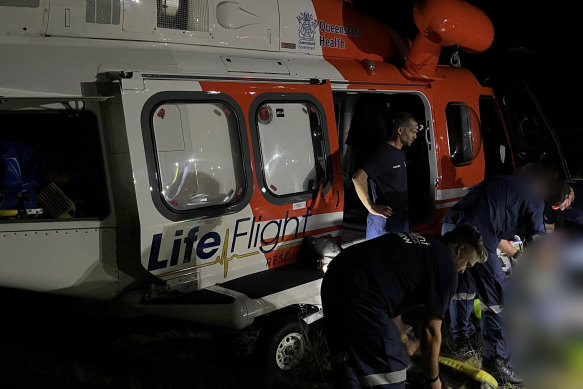 Paramedics work at the crash site west of Childers on Friday night.