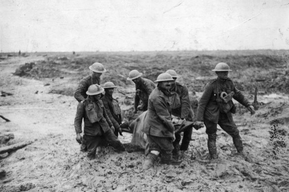 Soldiers carry a wounded mate through the mud during the battle of Passchendaele in Flanders in WWI.