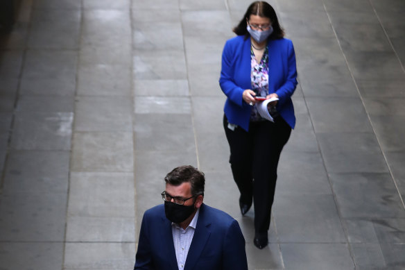 Jenny Mikakos trails Premier Daniel Andrews into a daily press briefing.