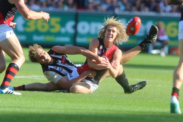 Dyson Heppell gets a handball away under pressure in a standout performance in the 2014 Anzac Day match.