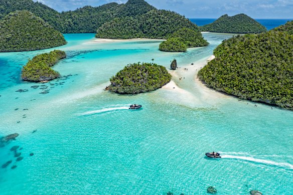 Zodiacs exploring Wayag Island in Raja Ampat.