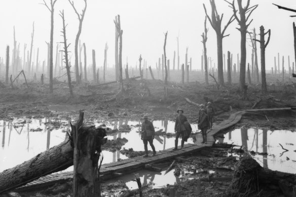 Soldiers walk on a duckboard across the shattered landscape during the Battle of Passchendaele in 1917. 