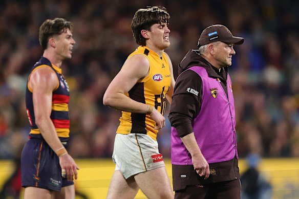 Will Day hobbles off Adelaide Oval.