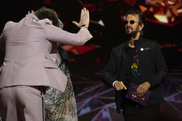 Finneas bows toward presenter Ringo Starr as he goes on stage to accept the award for record of the year for Billie Eilish’s Everything I Wanted.