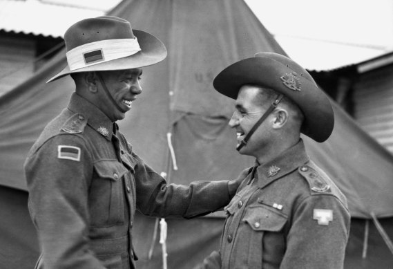 Lieutenants Reginald Saunders and Tom Derrick VC congratulate each other on receiving their commissions in November 1944. The two men shared a tent during their officer training.