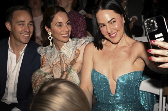 Digital strategist Katherine Galvin (right) enjoys the opening runway for the Brisbane Fashion Festival.