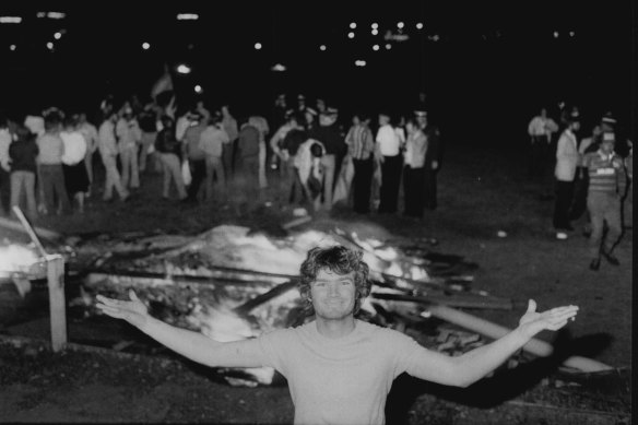 Burn, baby, burn ... a fan stands in front of the smouldering remains of the Cumberland Oval grandstand in 1981.