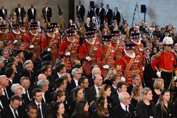 The Yeomen of the Guard march into Westminster Hall ahead of the King.