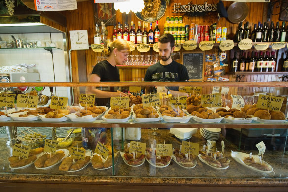 Staff lay out cicchetti for lunchtime service at a bacaro. 