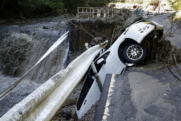A vehicle falls off collapsed road in the typhoon-hit Kakuda city, Miyagi prefecture, northern Japan on Sunday.