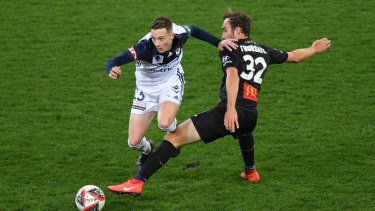 Victory's Anthony Lesiotis rides a tackle from the Jets' Angus Thurgate at AAMI Park on Wednesday.