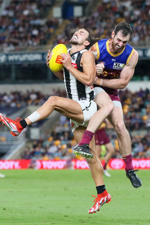 Crunch: Josh Daicos is cleaned up by Darcy Gardiner after taking a mark.