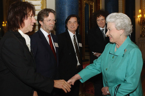  Queen Elizabeth II meets legendary guitarists (L-R) Jeff Beck, Eric Clapton, Jimmy Page and Brian May at Buckingham Palace in 2005.