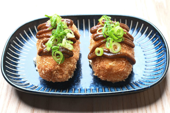 A squiggle of tonkatsu sauce decorates the smoked kingfish and potato croquettes.