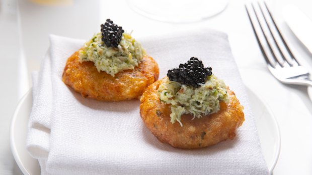 Sabudana vada, an Indian potato and tapioca fritter, topped with crab.