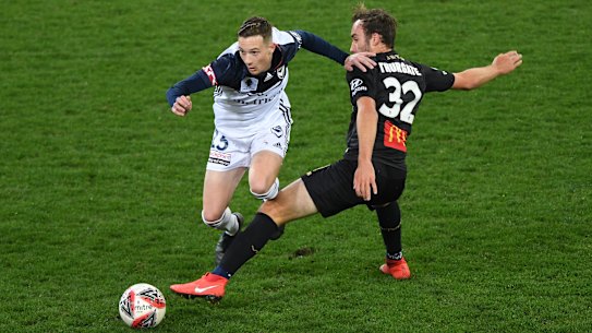 Victory's Anthony Lesiotis rides a tackle from the Jets' Angus Thurgate.