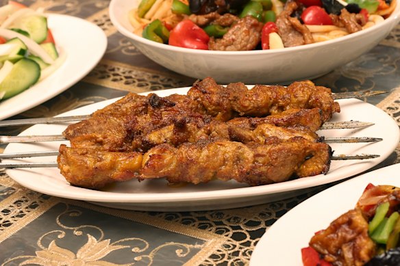 Tender lamb shoulder skewers are marinated in raw onion overnight, cooked over charcoal and seasoned with cumin. 