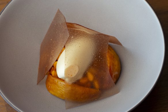 Malfroy’s honey thyme ice-cream, roasted peach and macadamia is teepeed with toffee shards.