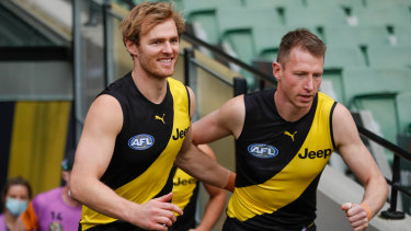 Richmond retiree and triple-premiership player David Astbury runs on to the field for his final game alongside great mate Dylan Grimes.