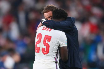 England manager Gareth Southgate consoles Bukayo Saka after the defeat to Italy.