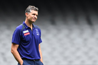 Dockers coach Justin Longmuir will miss the derby against the West Coast Eagles on Sunday after going into health and safety protocols.